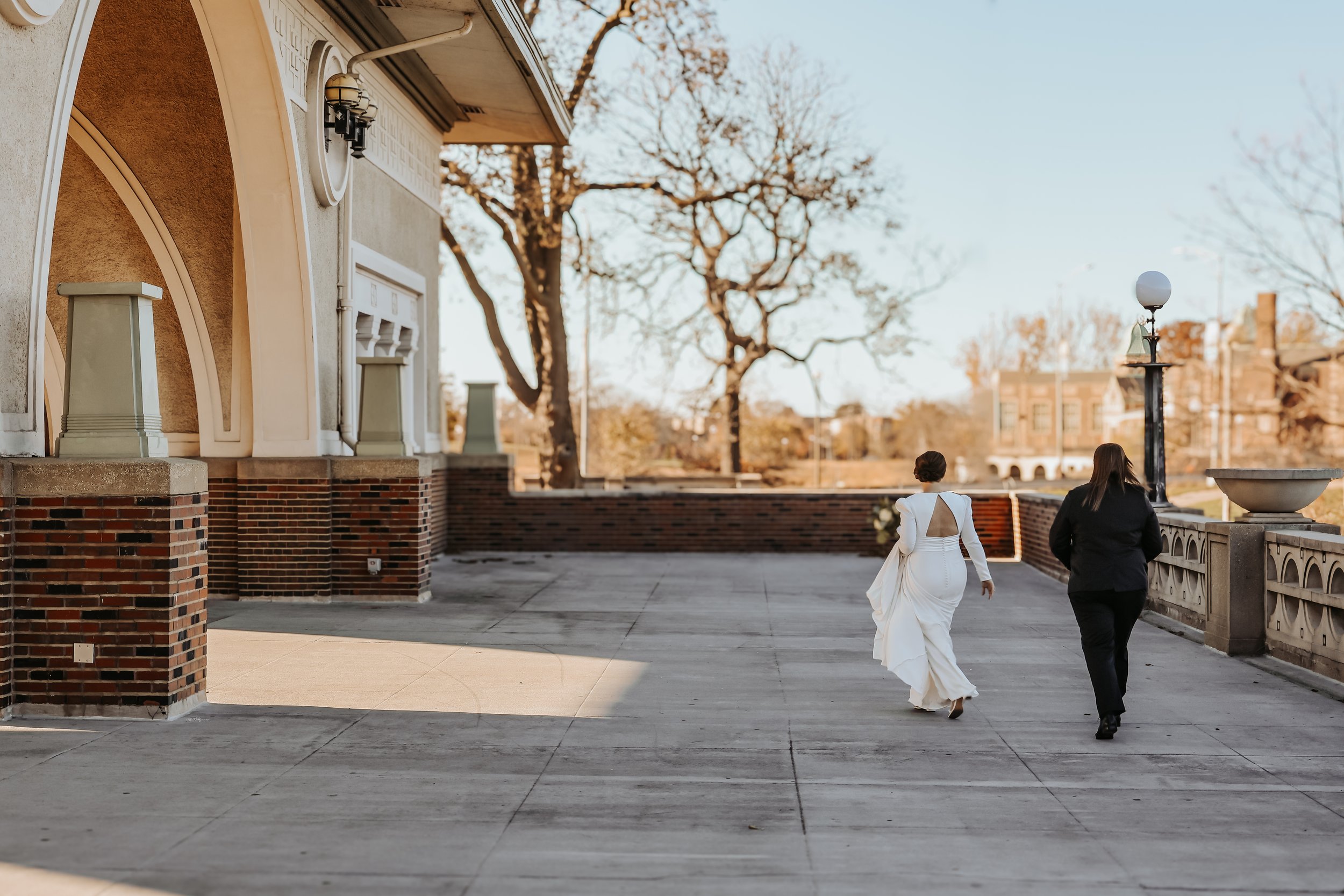 Two brides stroll along the deck of the Humboldt Park Boathouse in Chicago, IL.