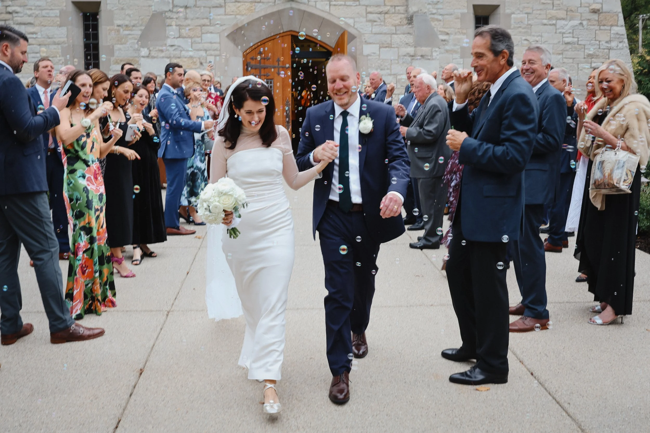 A Chicago bride and groom leave Saint Francis Xavier Catholic Church after their wedding ceremony in Wilmette, IL.