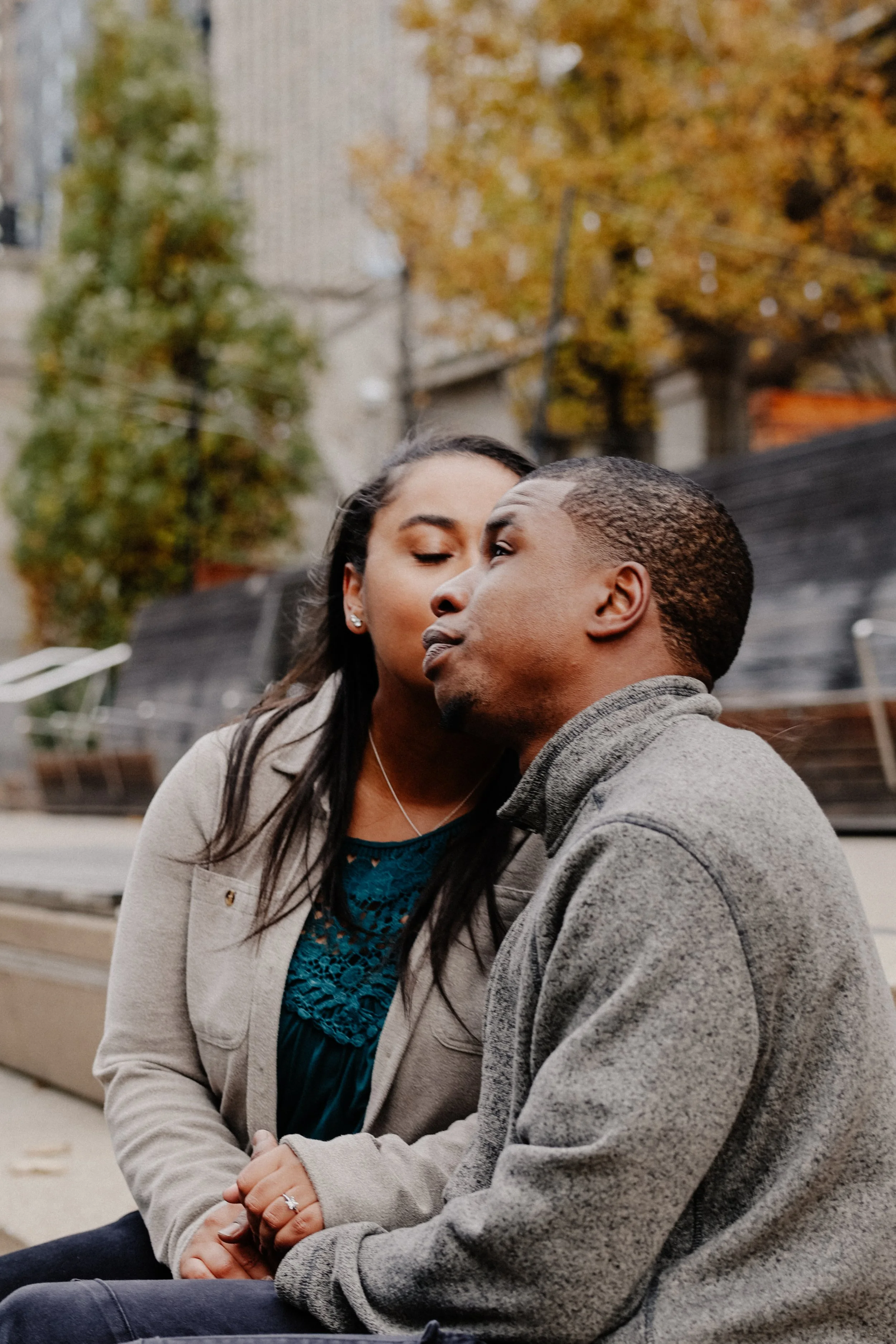 Engaged couple poses for a photo on the riverwalk in Chicago.