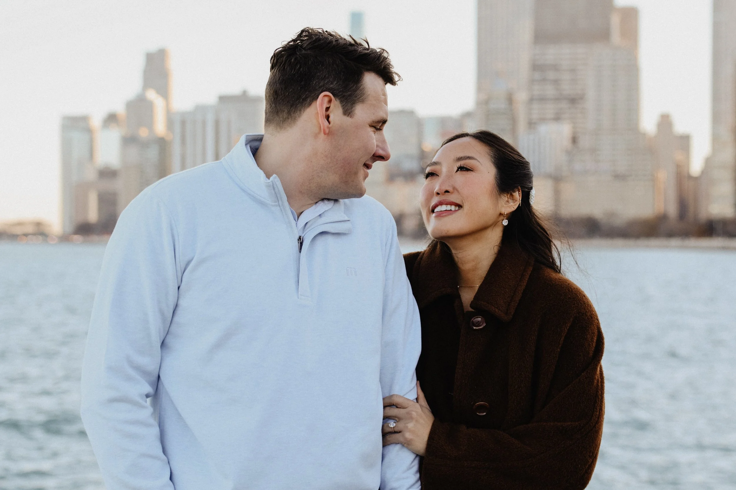 An engaged couple poses for photos on the lakefront in Chicago, IL.