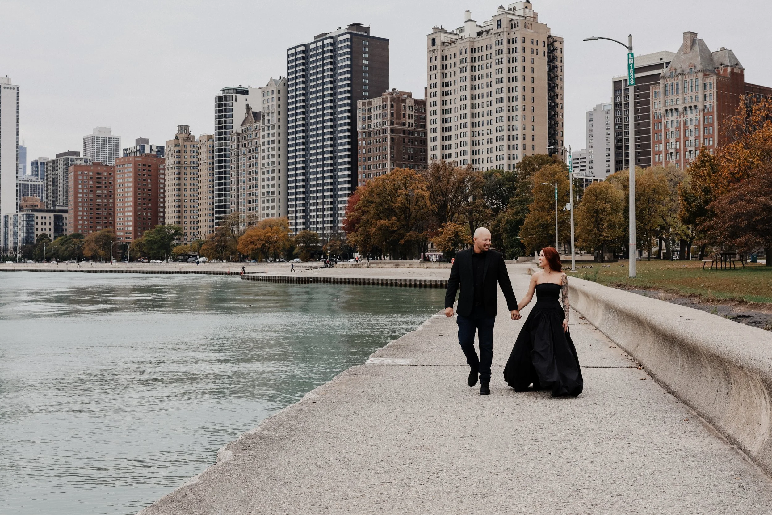 A couple walks at North Avenue Beach after their Chicago elopement.