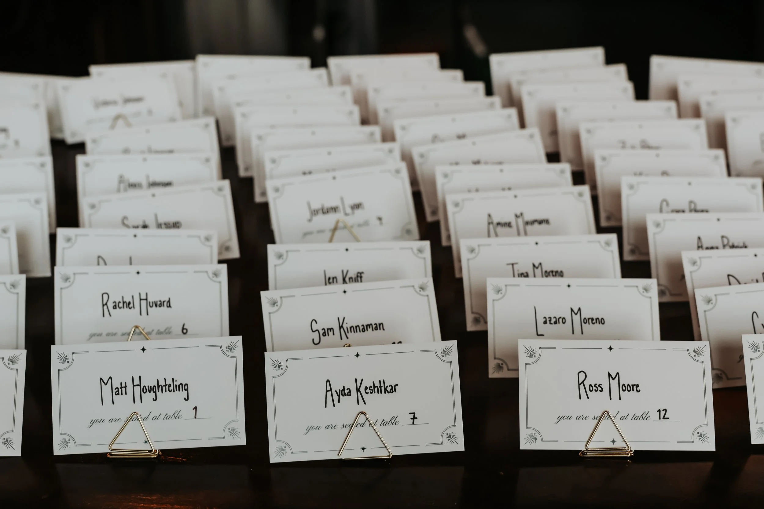 A table full of art deco 20s style wedding place cards in Chicago, IL.