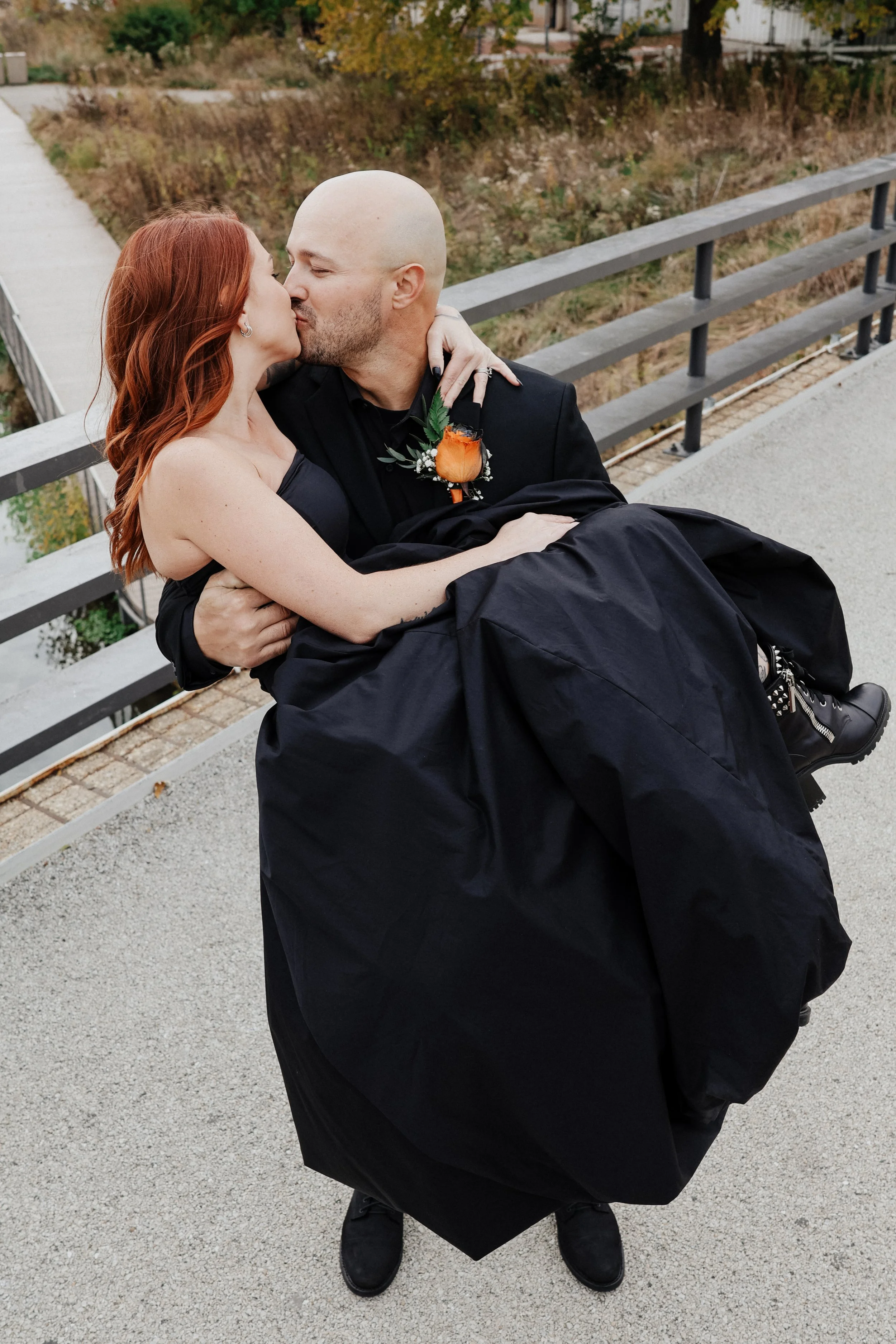 A groom and bride stand on a bridge in Lincoln Park, Chicago, Illinois.