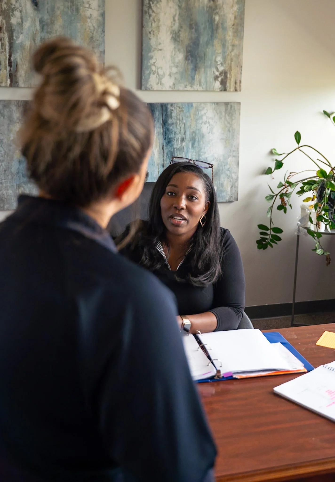 Alicia Hill in conversation across a desk
