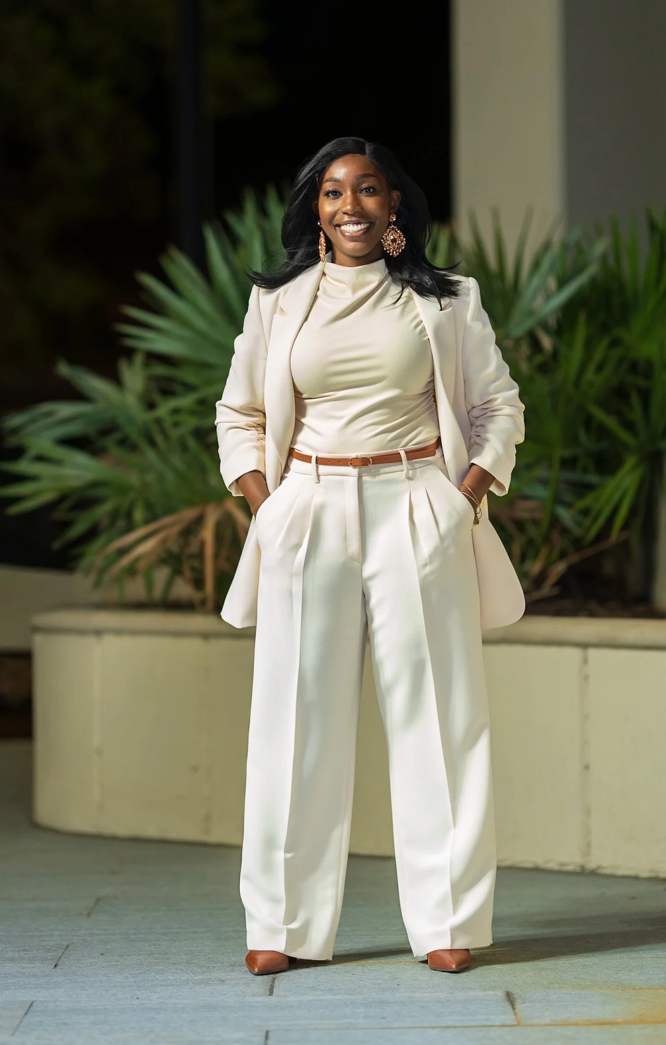 Full-length portrait of Alicia Hill in a cream-colored suit