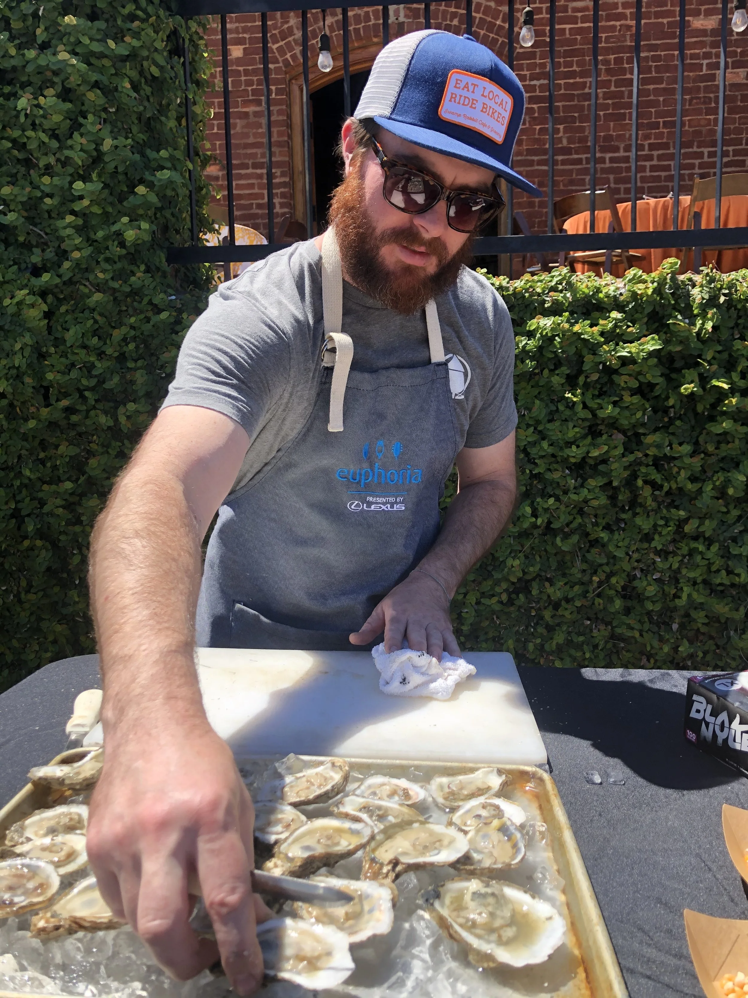 Chef Austyn McGroarty preparing food outdoors in Greenville, South Carolina.