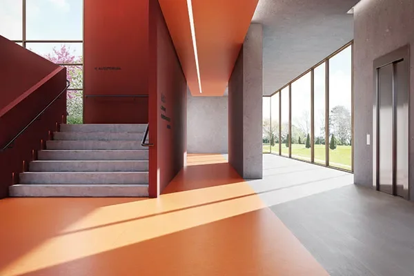 Modern interior space with staircase, large windows, and open area with bright sunlight and bio based pvc free resilient sheet flooring.