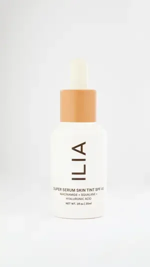  Lila skin care oil in an elegant glass bottle, displayed on a natural wood background with soft lighting.
