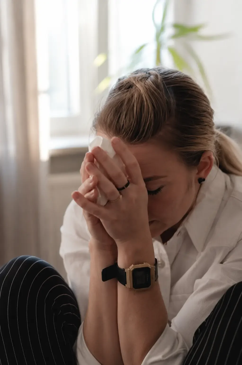 Woman sitting quietly feeling emotionally exhausted and overwhelmed in a calm home setting in Townsville
