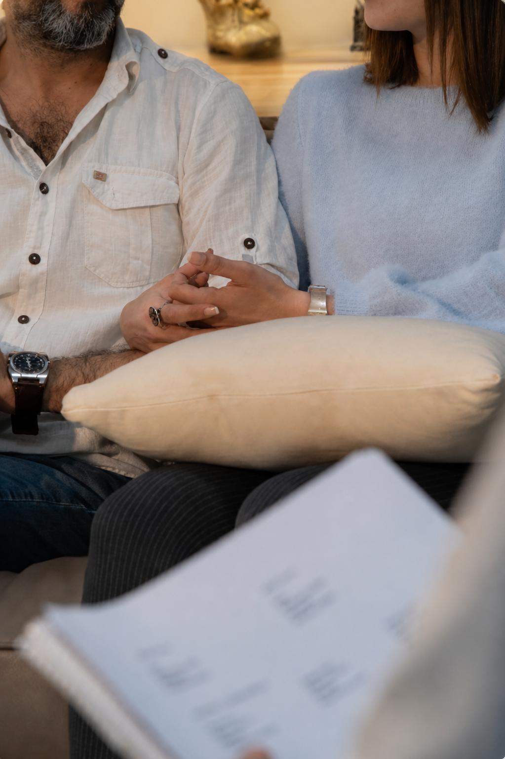 Couple sitting together quietly but emotionally disconnected during relationship counselling