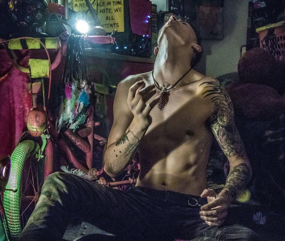 A performer amid stage light and colour