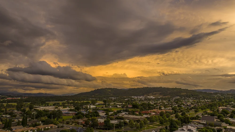 Cityscape at sunset with dramatic cloudy sky