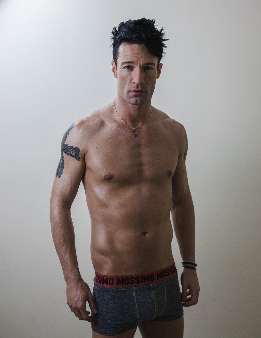 Shirtless man wearing Mossimo underwear posing against a plain background.