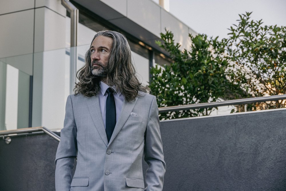 Amos Ashley in a grey jacket, photographed outdoors