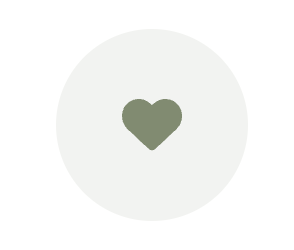 A green heart icon centered on a light gray circular background.