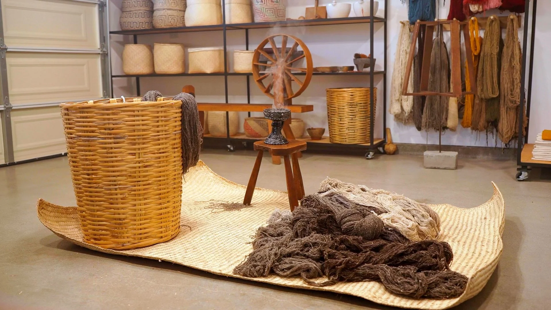 A display of woven baskets, yarn, and textile arts in a store or craft shop.