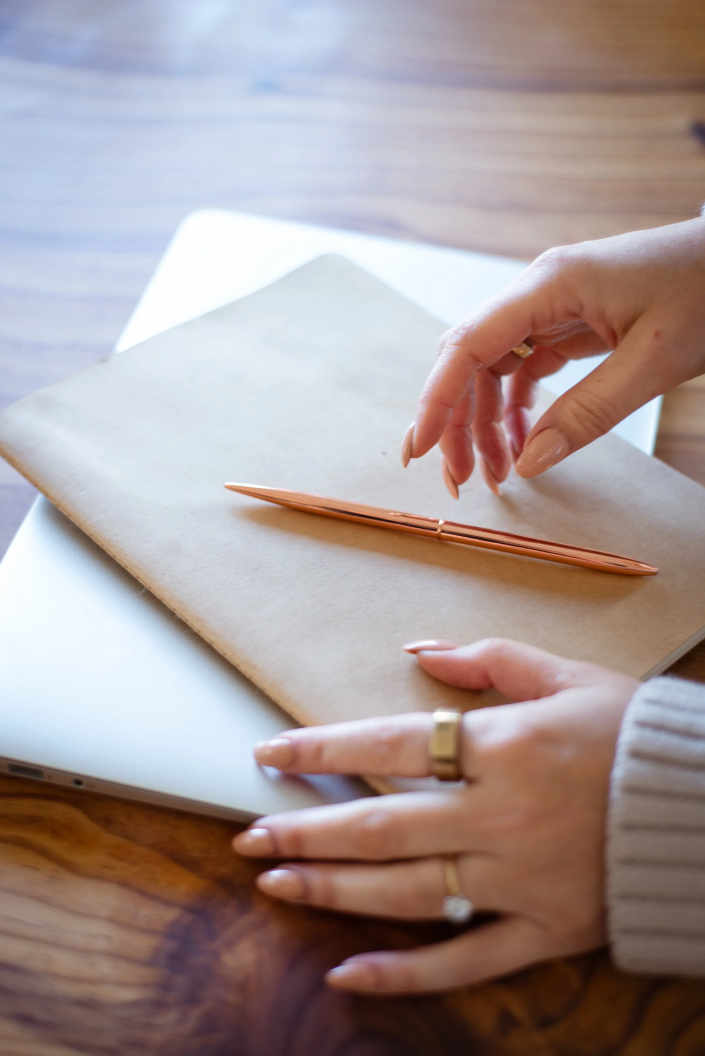 Close-up of woman's hands with journal and pen — biblical healing tools, self-reflection, and mindset work for Christian women