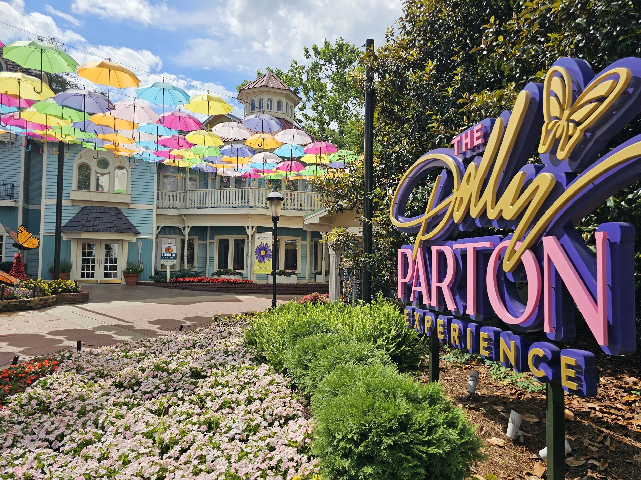Dolly Parton Experience Sign with the umbrellas in the background