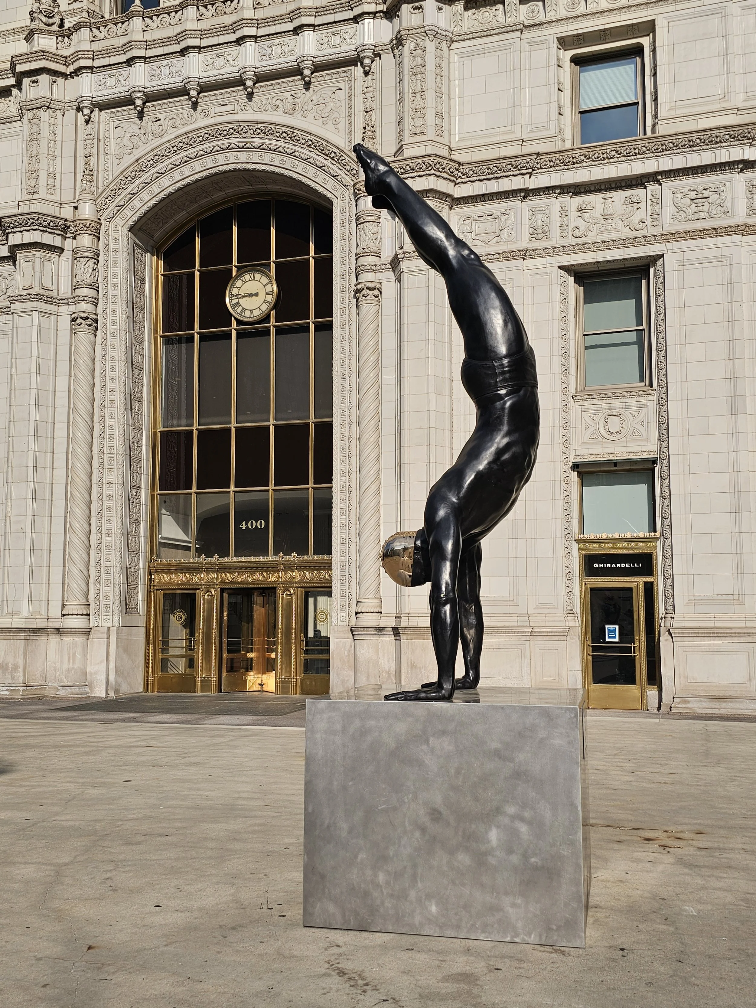A statue of a diver from the side full length