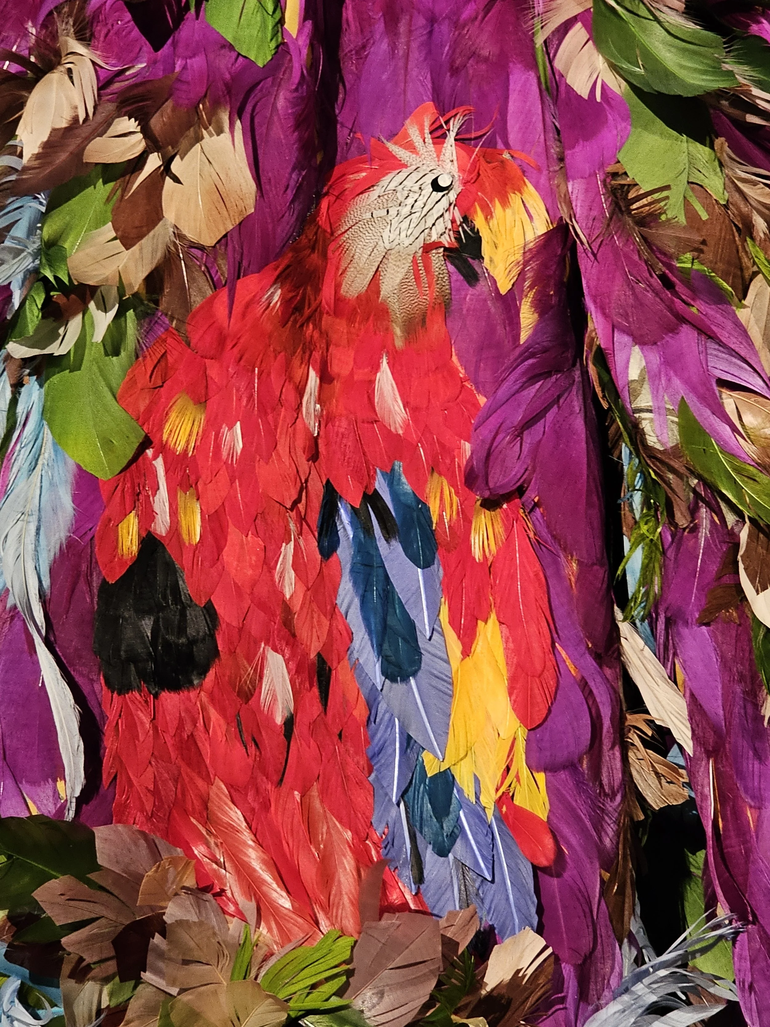 A close up of the feather shirt to show a parrot design