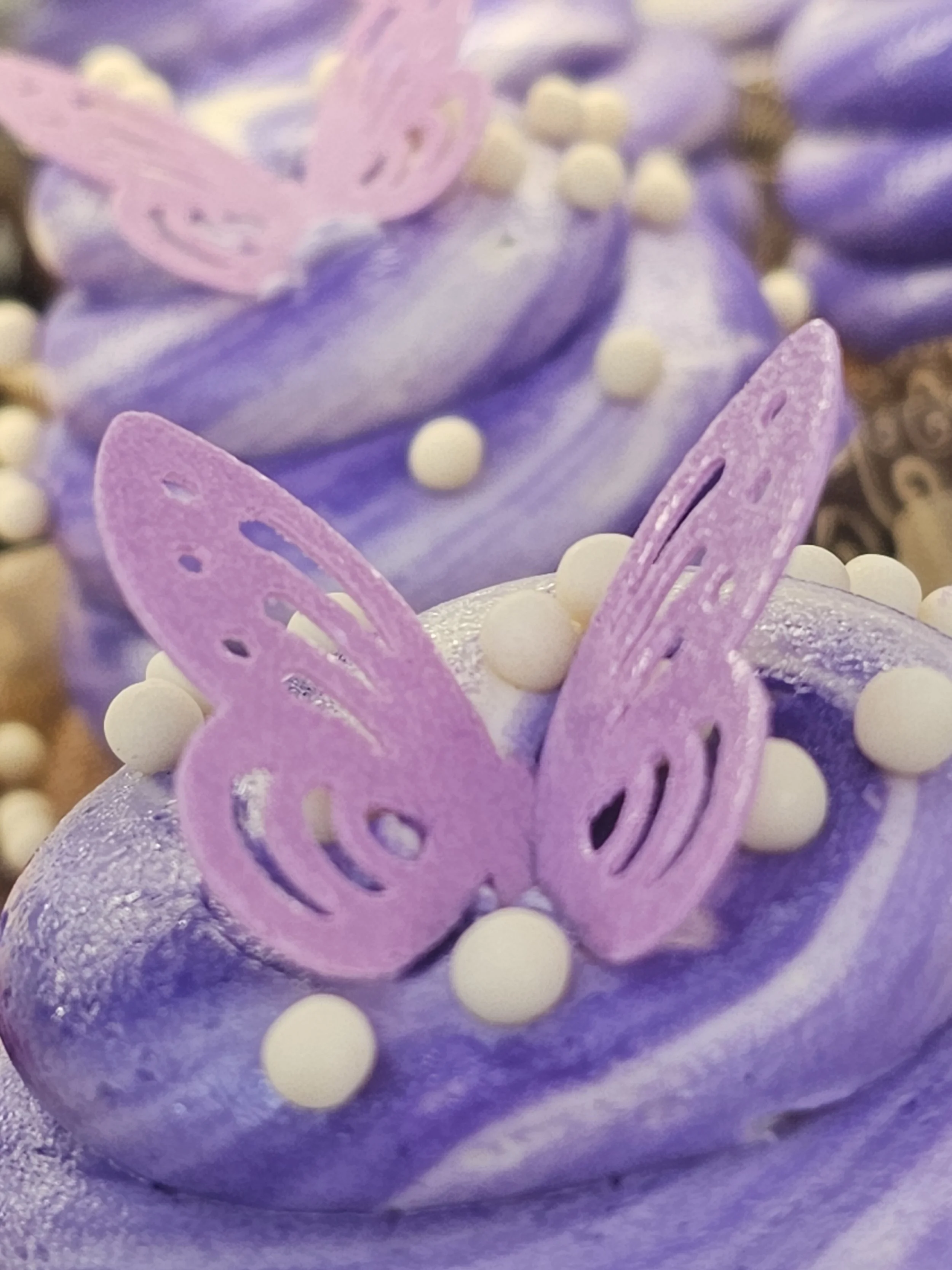 a cupcake with a purple butterfly