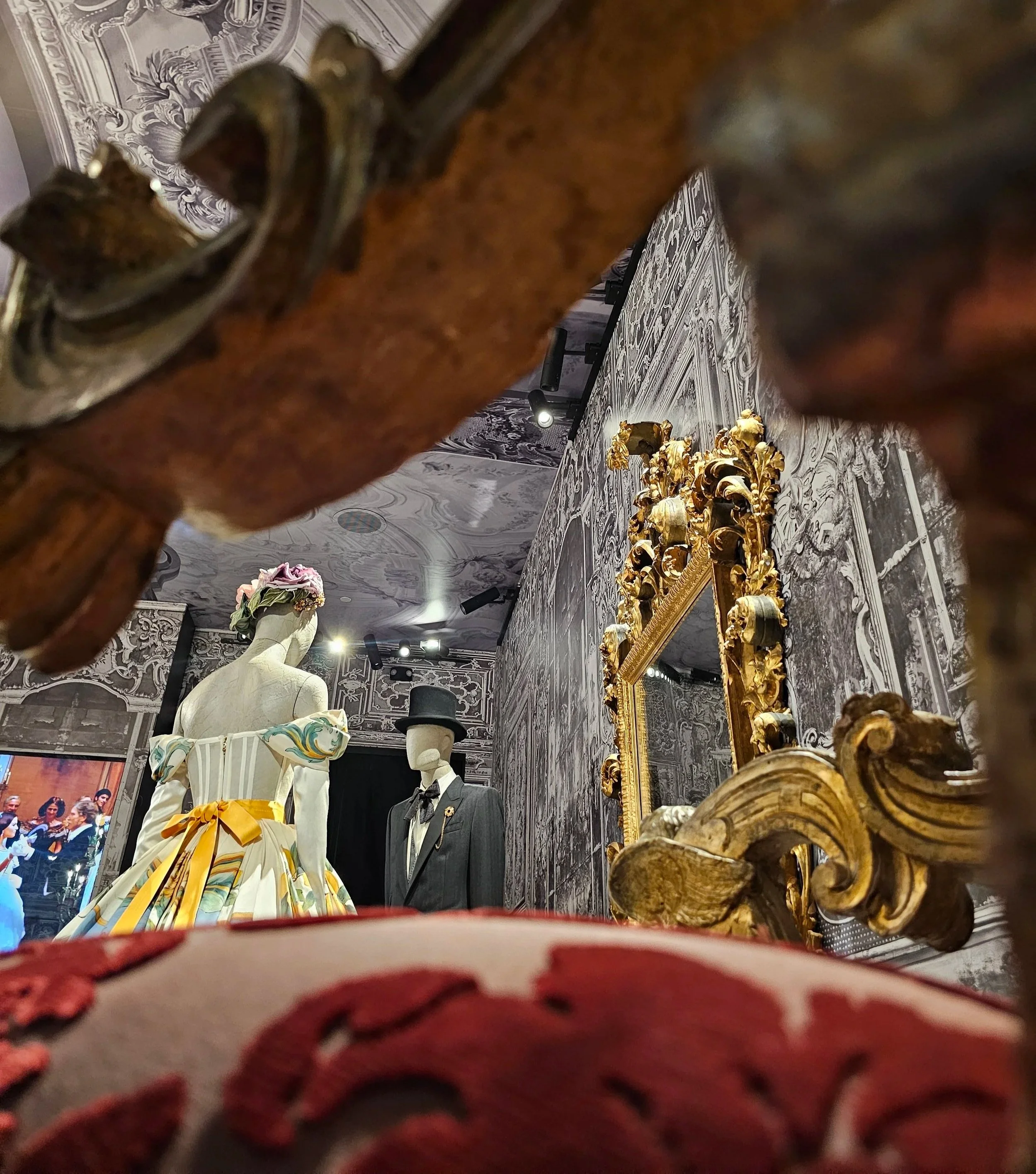 looking under the arm of a chair up at the display you see two mannequins
