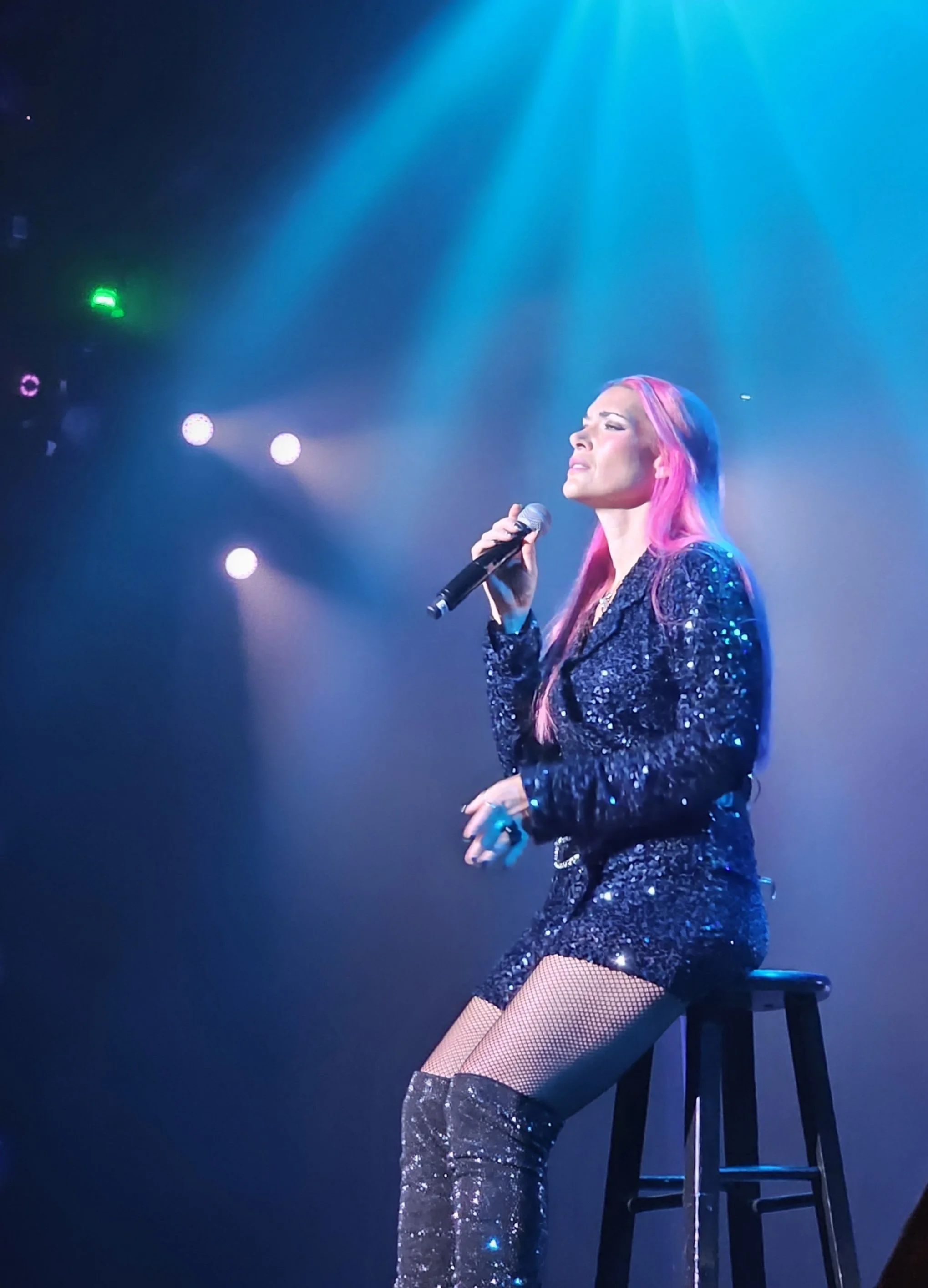 a singer with a bright light above her head.