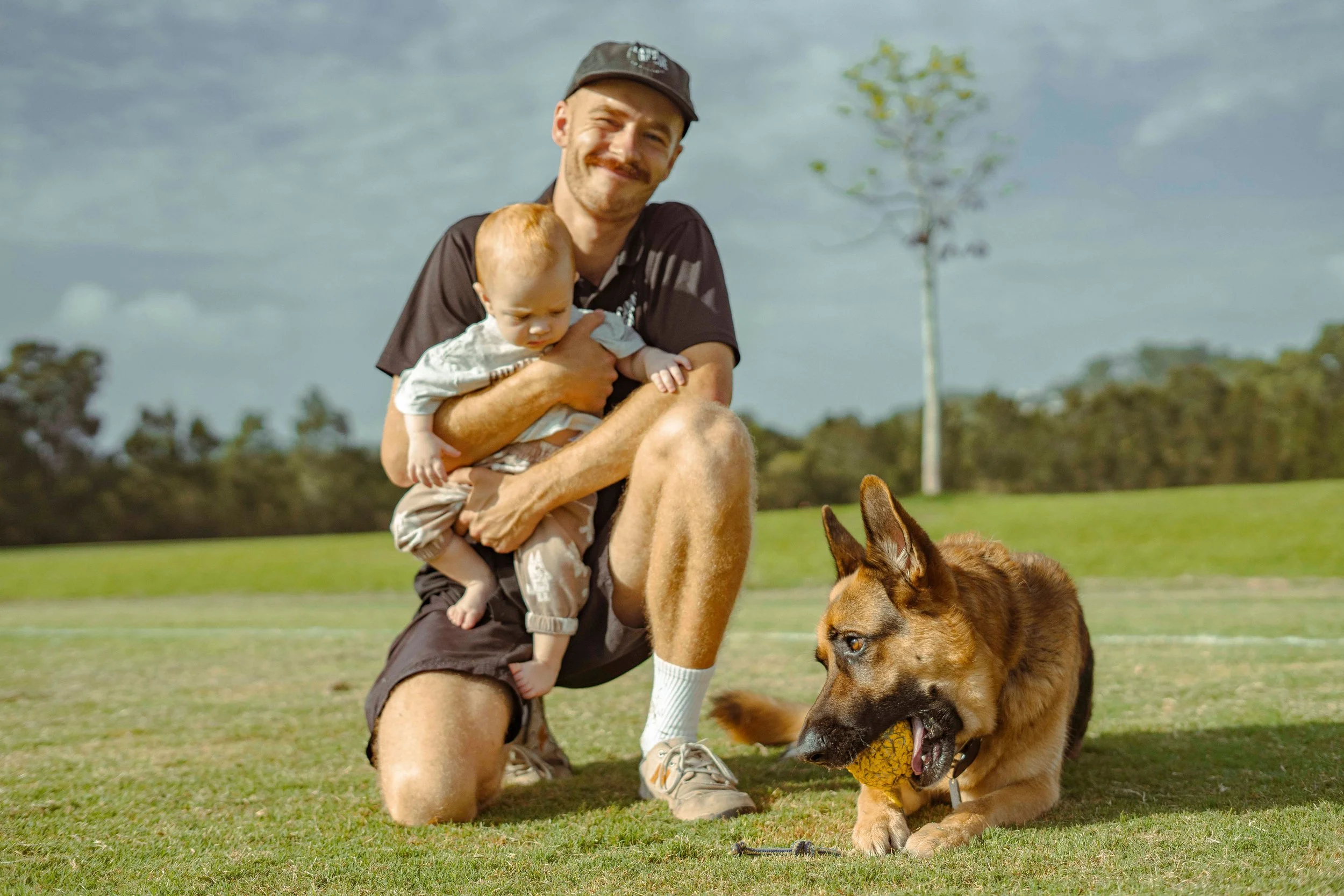 seb canines on cue dog trainer gold coast with baby and german shepherd