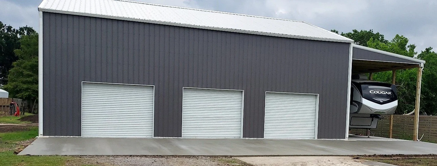 Corrugated Metal building with camper cover.