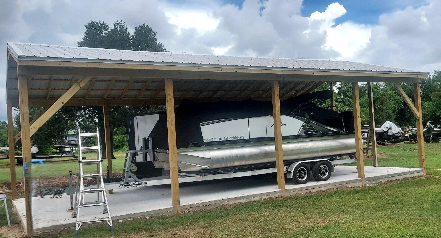 Free standing boat cover with R-panel corrugated metal roofing.