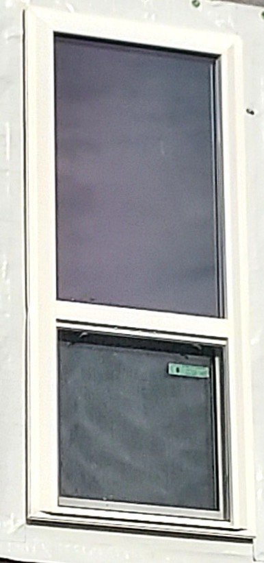 Window install before trim and siding application.