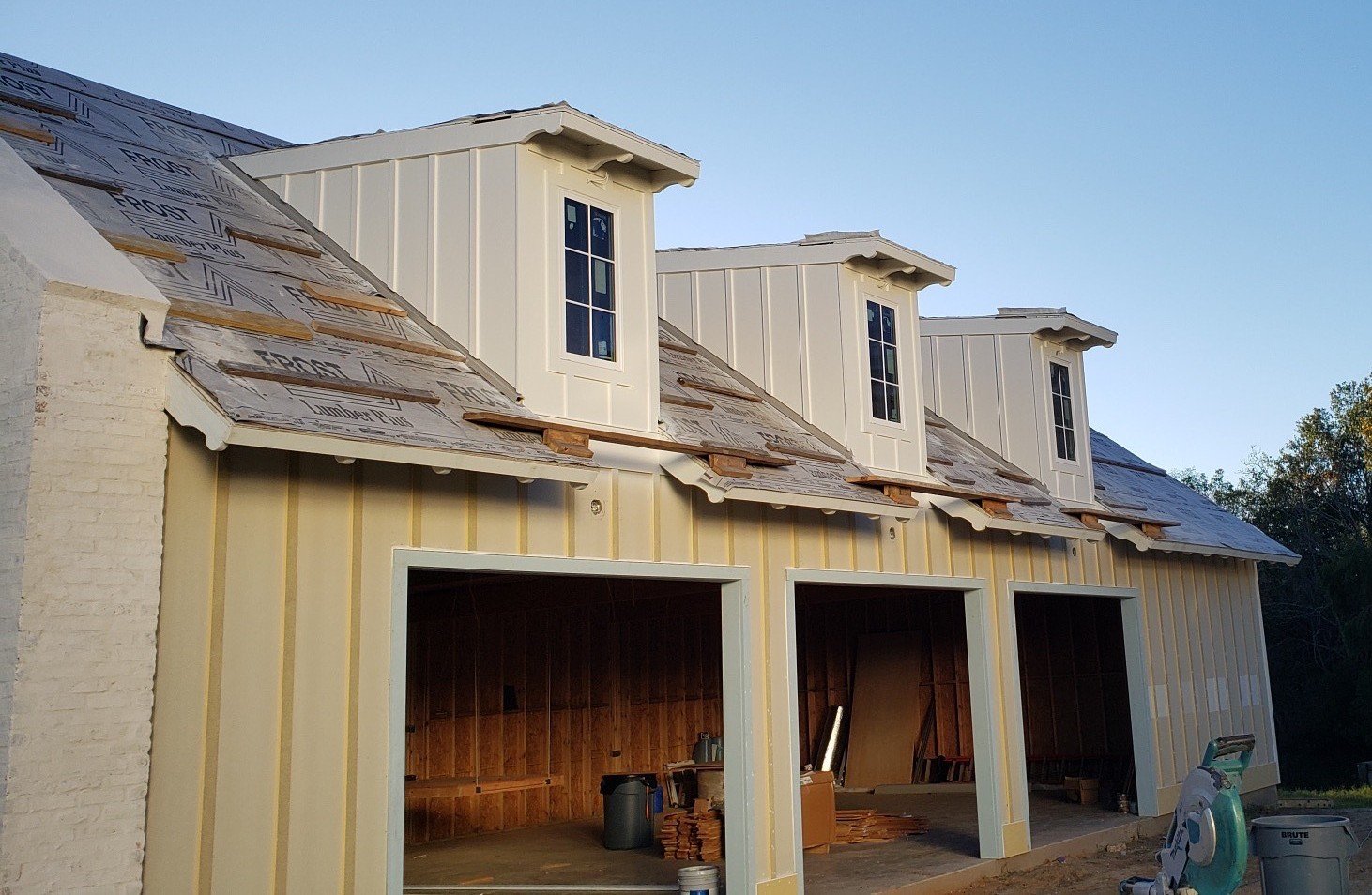 Three car garage with board and batten style Hardi siding. Accented trim on the three dormers. (1-2)