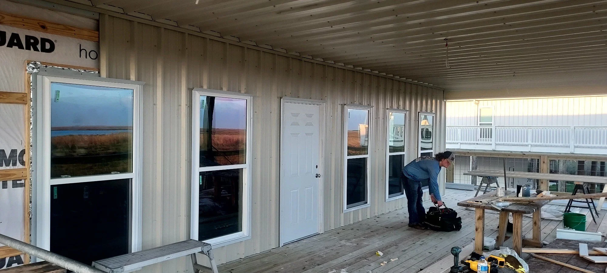 Corrugated metal camp, windows, and doors in progress. (3-4)
