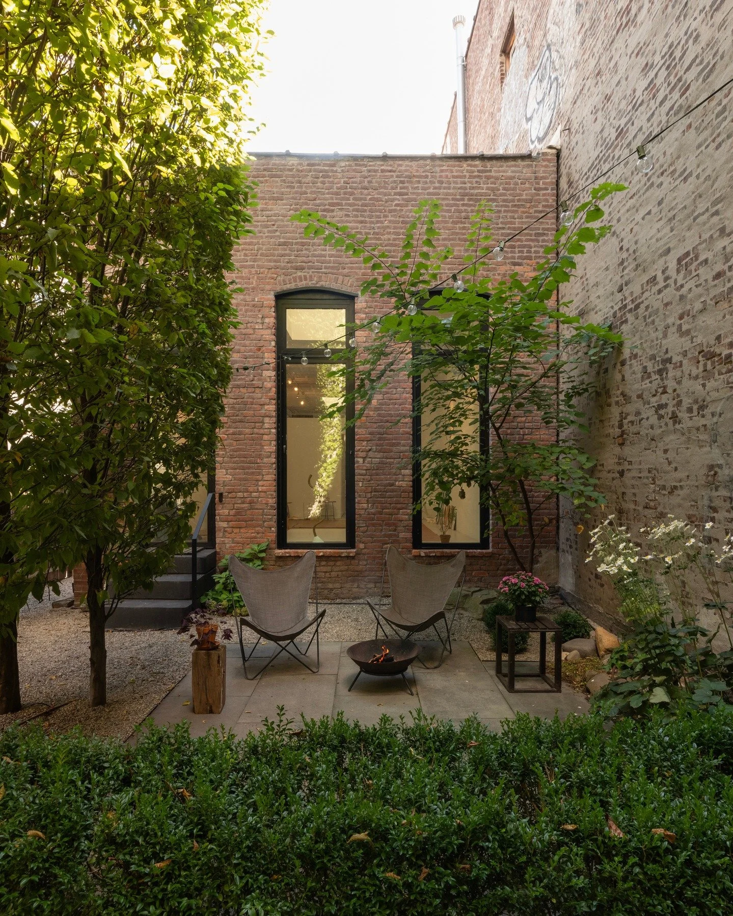 At our Tapestry House project in Ridgewood Queens NY, connecting the historic building with the landscape, for the first time ever, was a key goal. A century of debris was removed from the backyard, and a grid of hornbeam trees installed- influenced 