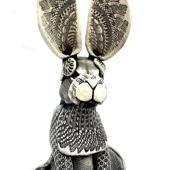 A black and white patterned stuffed rabbit with large ears.