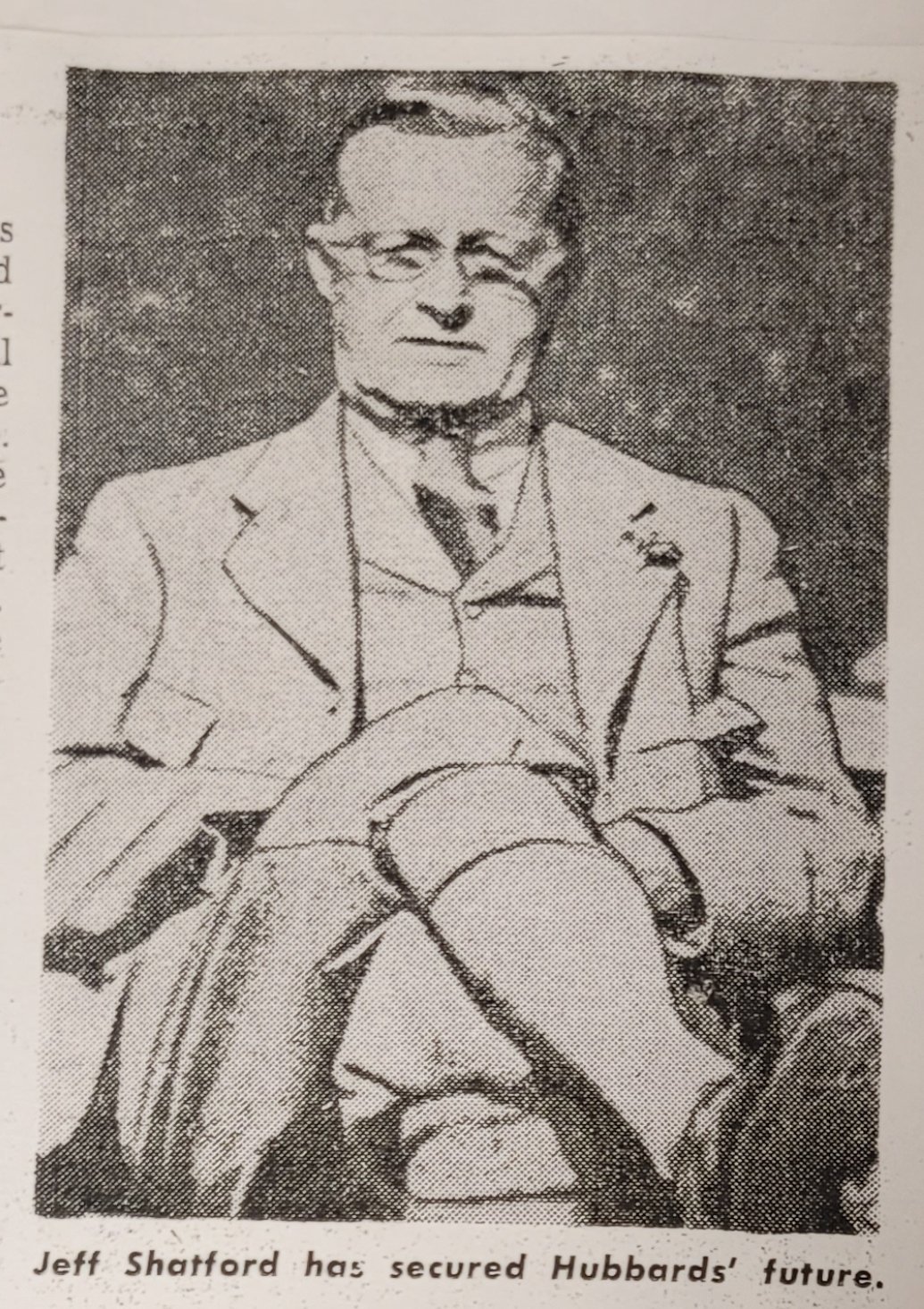 Vintage black and white photo of a man in a suit sitting with legs crossed, with glasses, appearing formal and composed. The text reads: 'Jeff Shafford has secured Hubbards' future.'