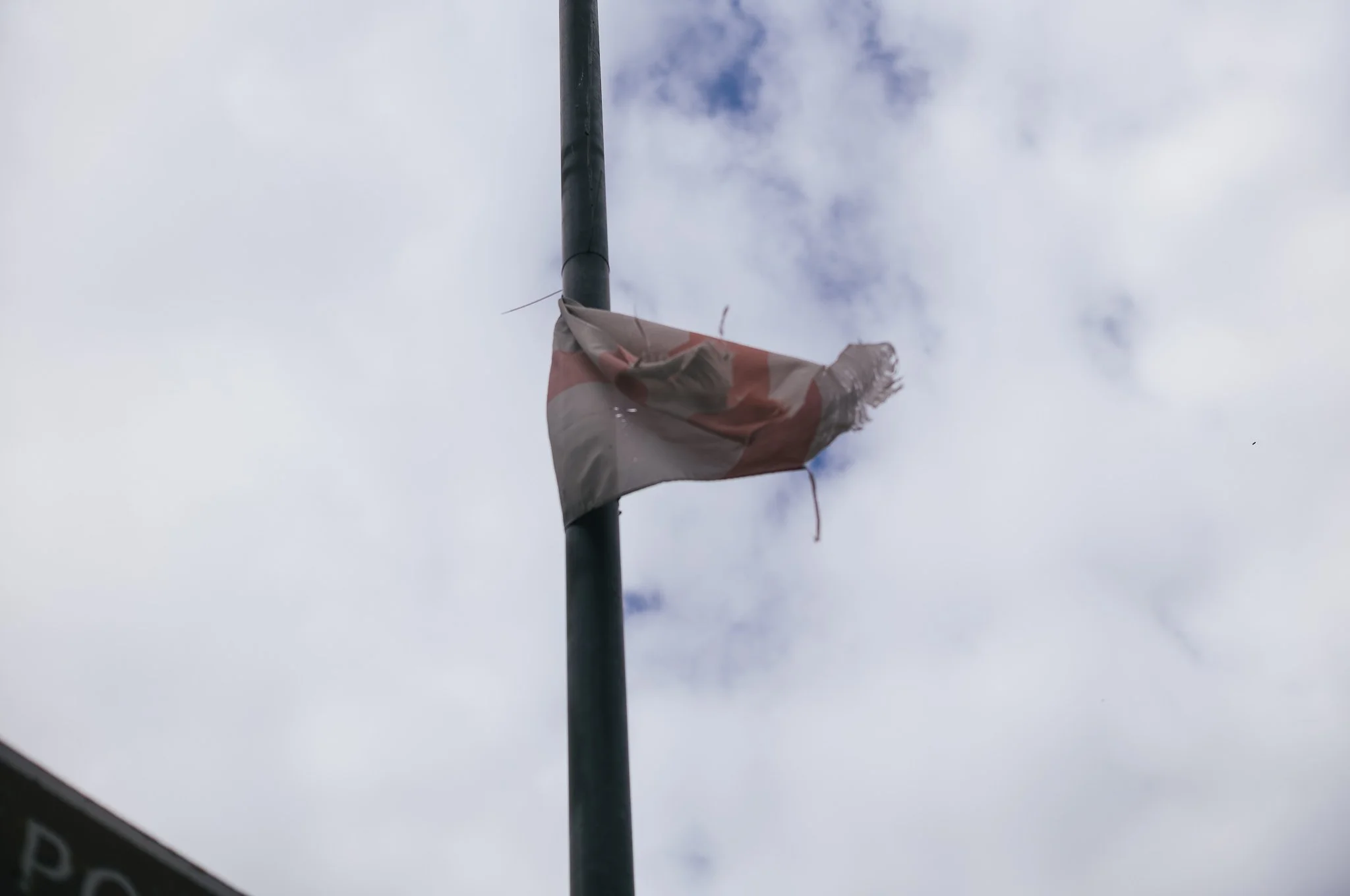 Tattered England flags hang from trees and lamp posts all around Pontefract