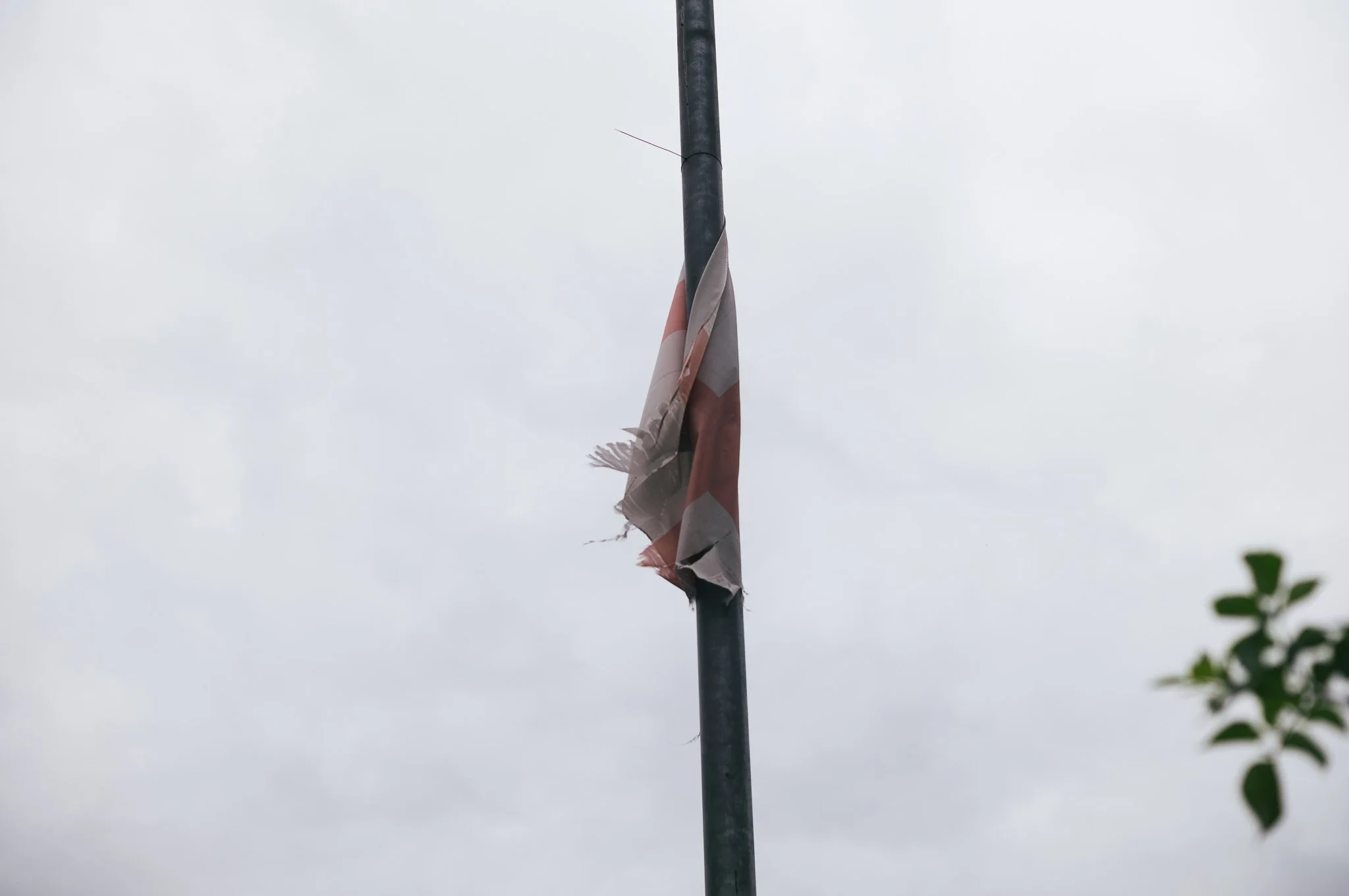 Tattered England flags hang from trees and lamp posts all around Pontefract