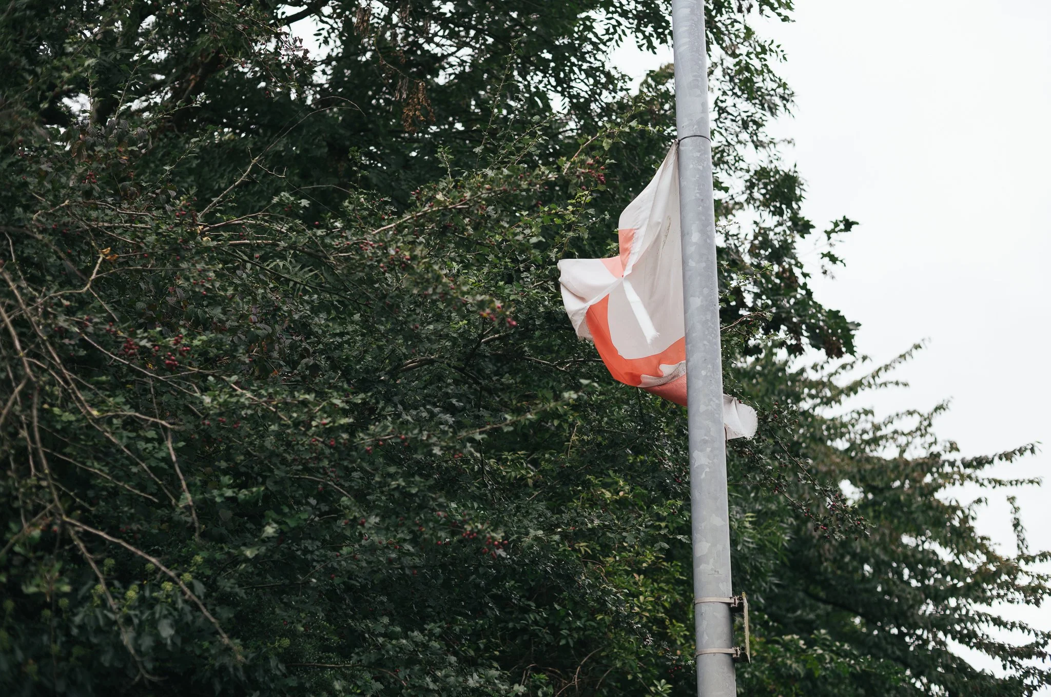 Tattered England flags hang from trees and lamp posts all around Pontefract
