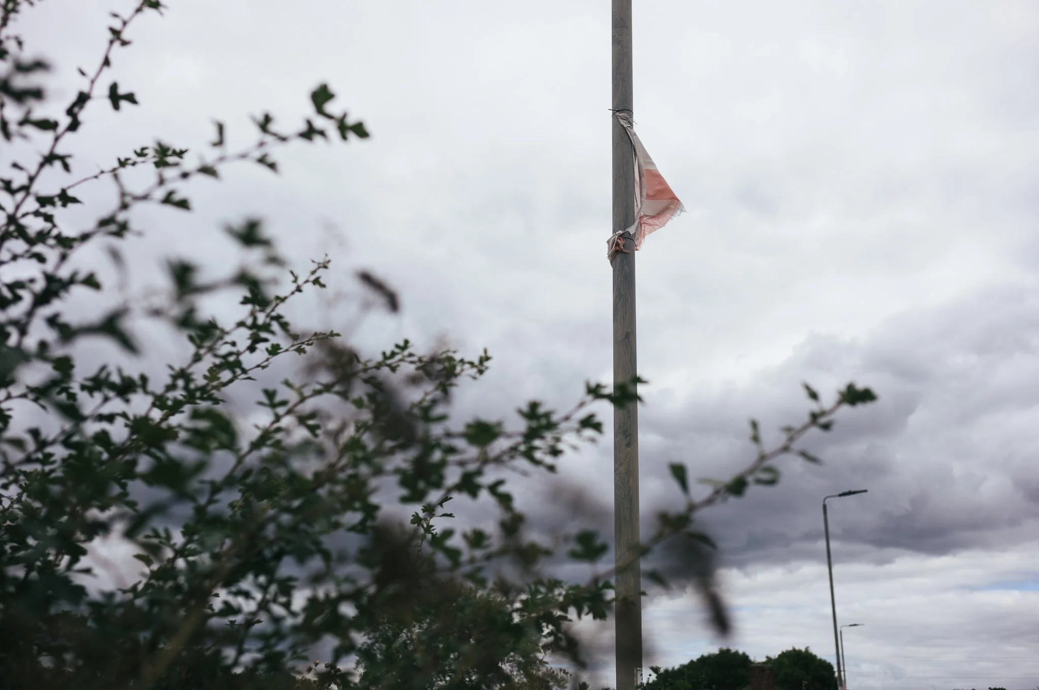 Tattered England flags hang from trees and lamp posts all around Pontefract