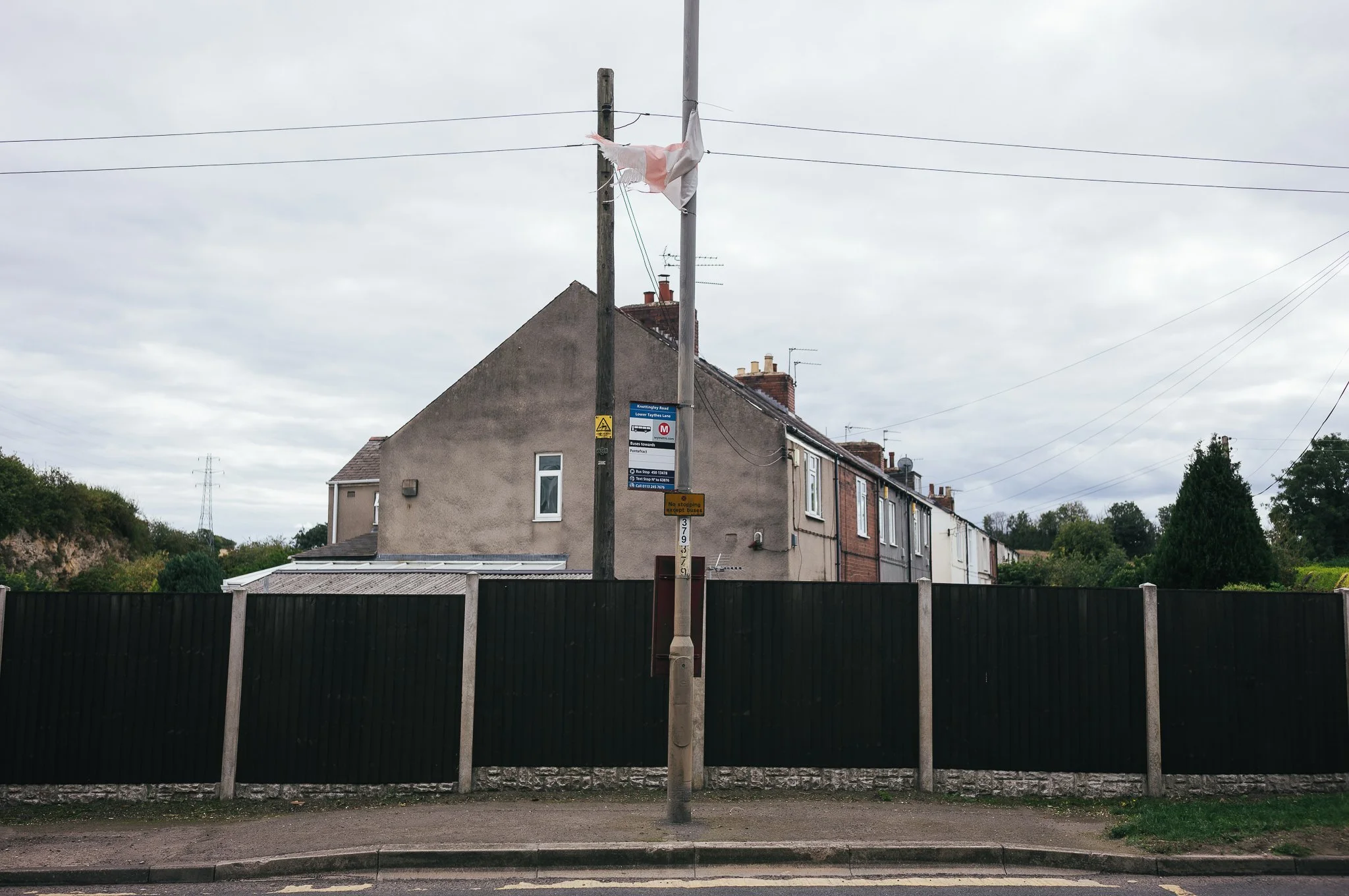 Tattered England flags hang from trees and lamp posts all around Pontefract