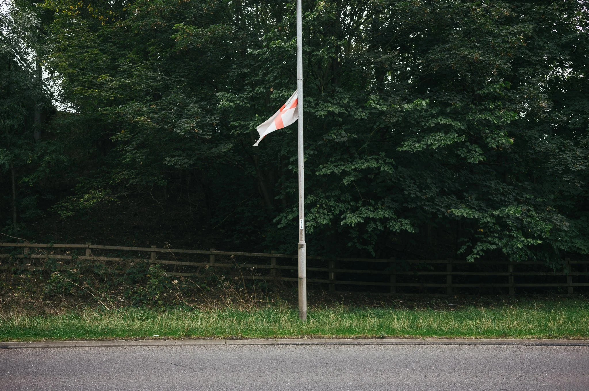 Tattered England flags hang from trees and lamp posts all around Pontefract