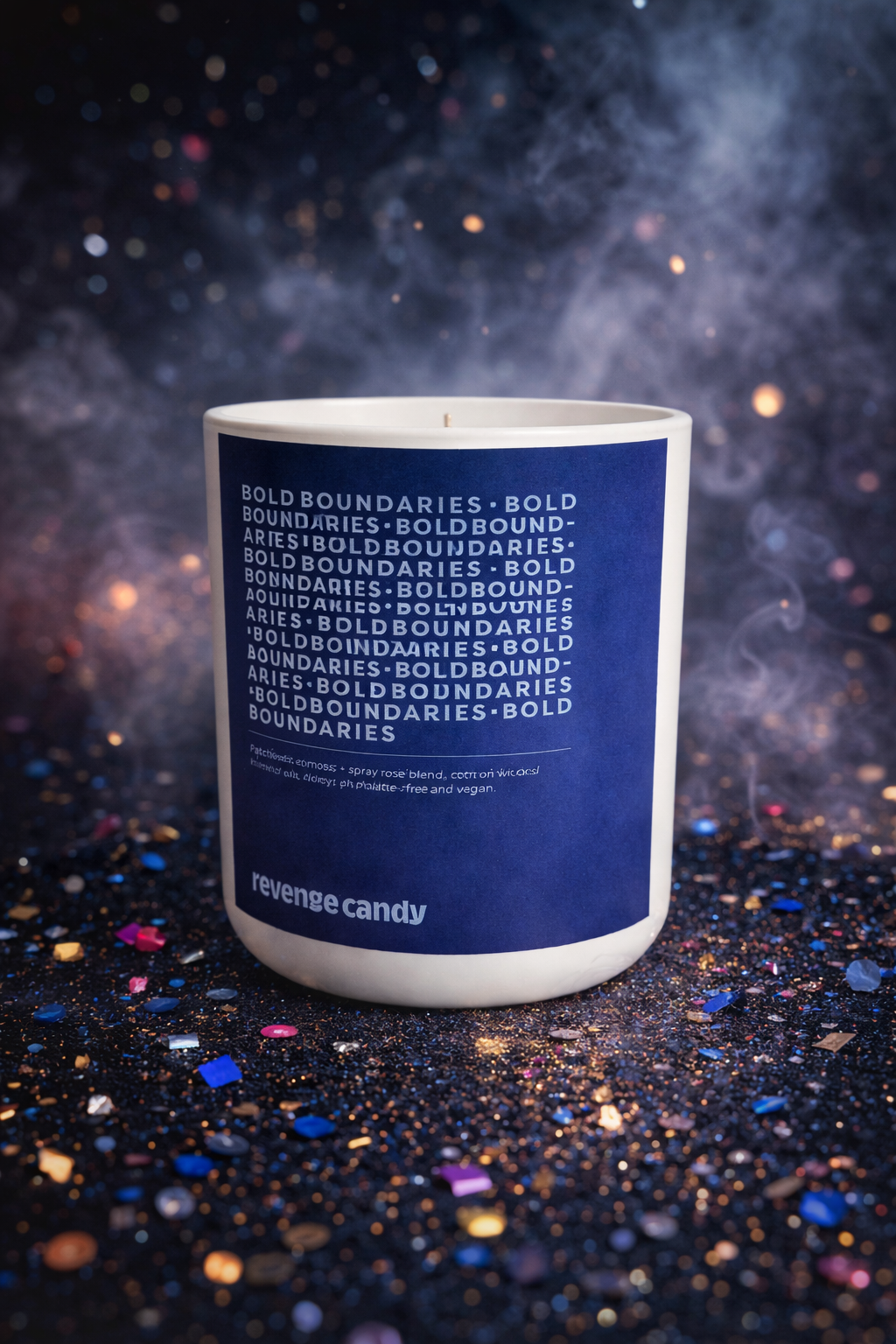 A candle in a white container with a blue label, surrounded by colorful glitter on a dark background.