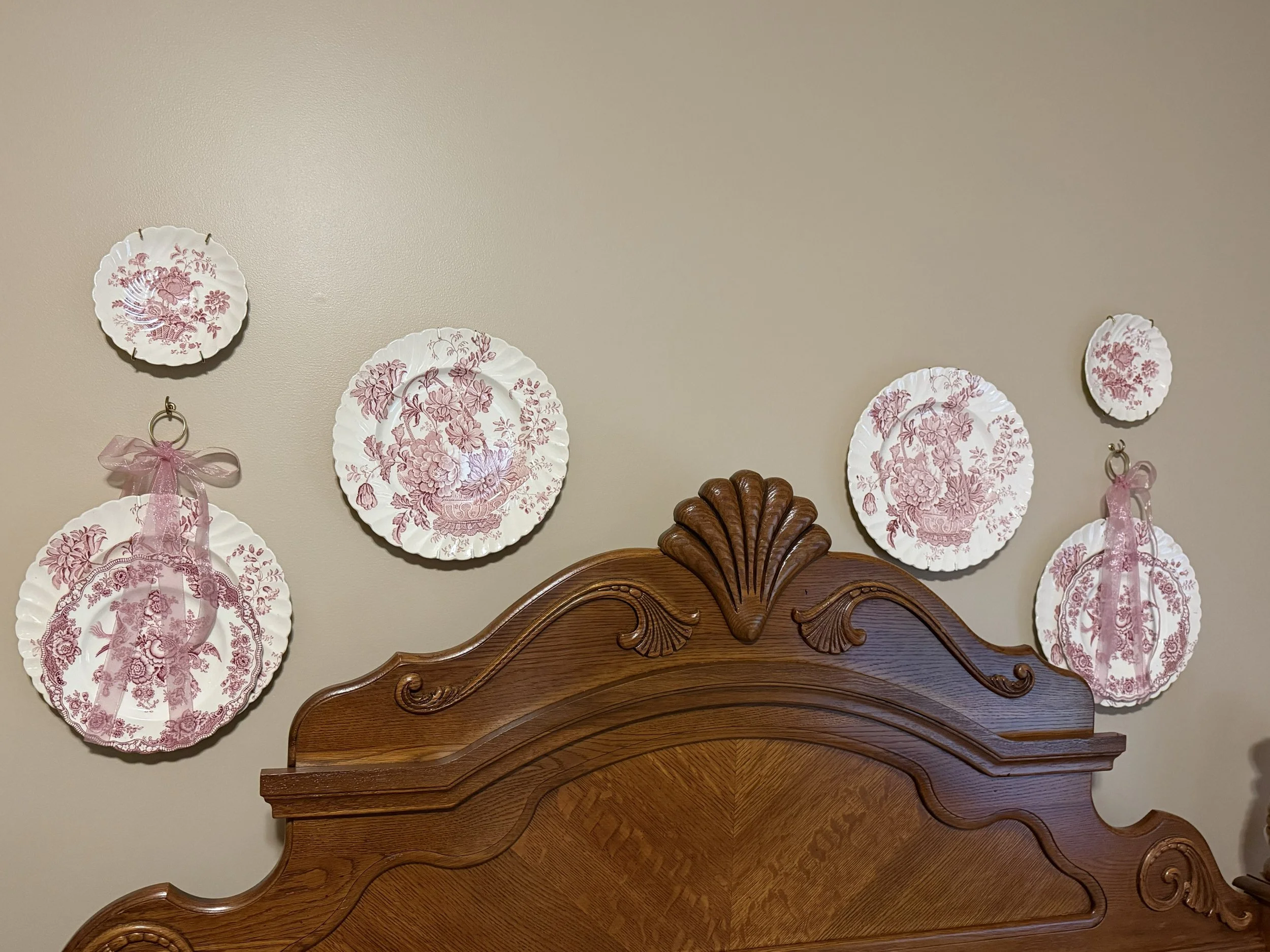 Pink floral dishes displayed on wall ribbons.jpg