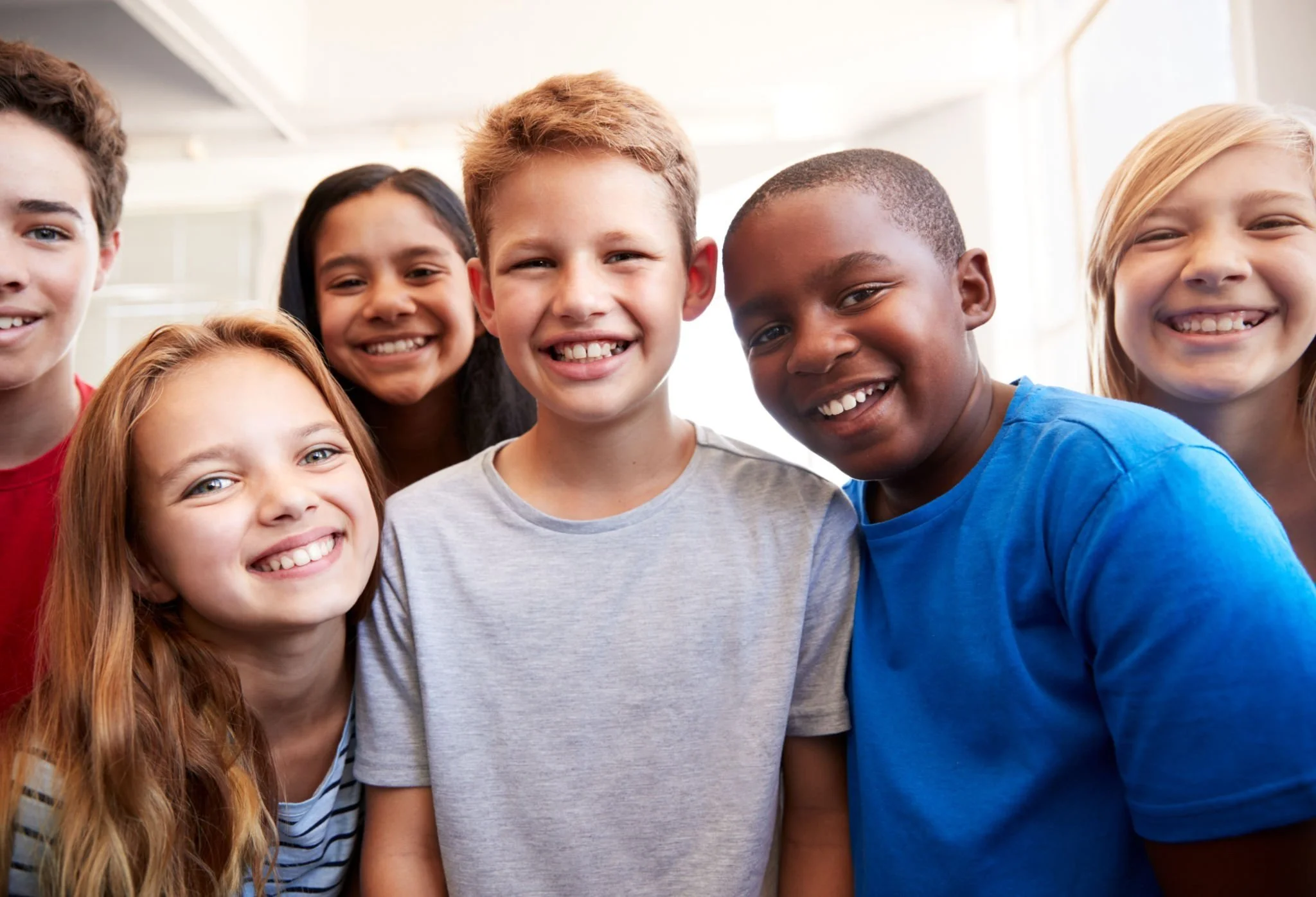 Group of smiling children posing at tutoring group.