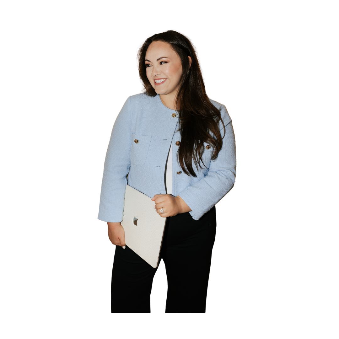 A woman with long dark hair smiling and holding a silver laptop, wearing a light blue blazer and black pants, standing against a background with color blocks.