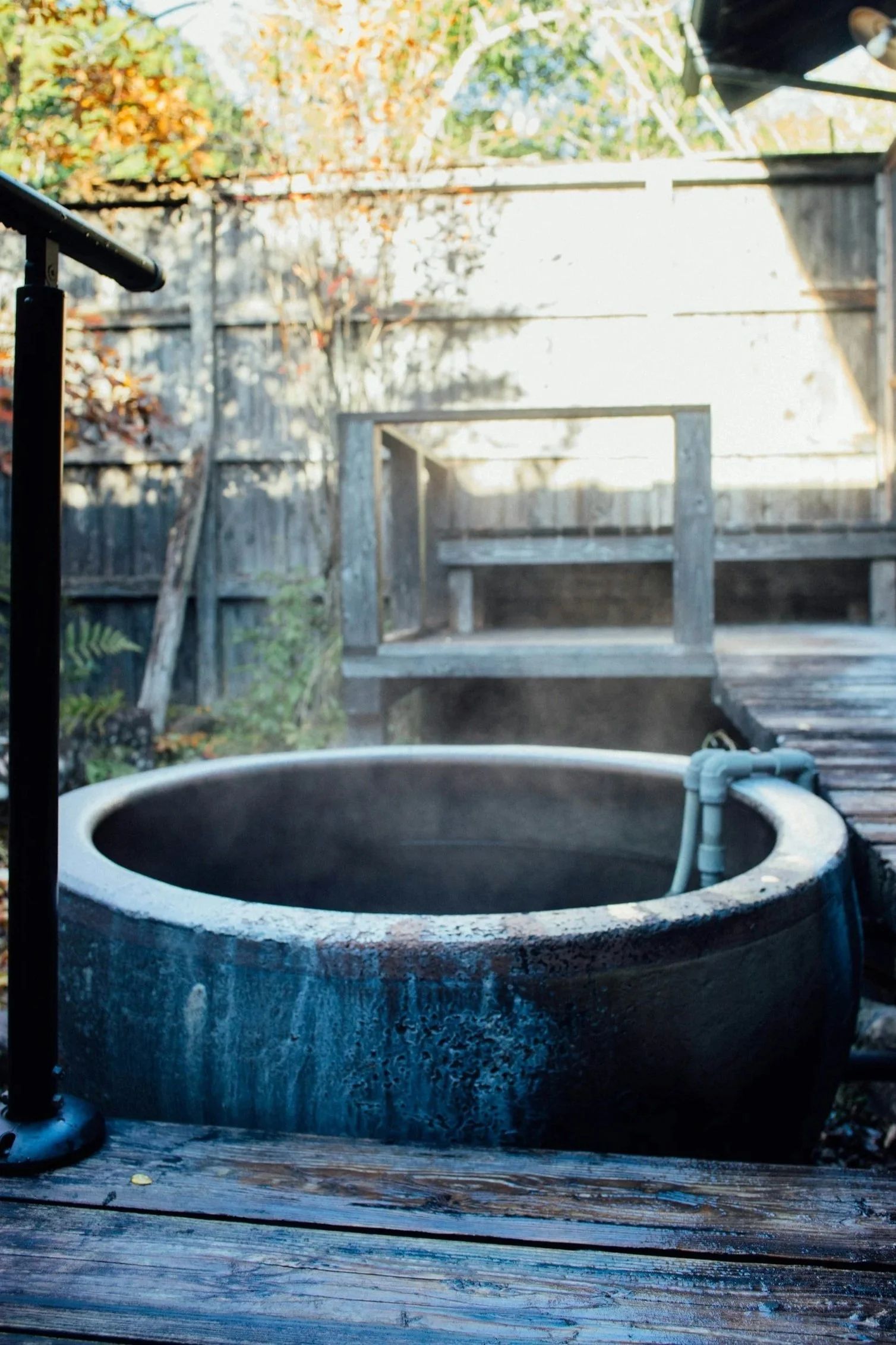 an onsen bath outside next to a wood platform