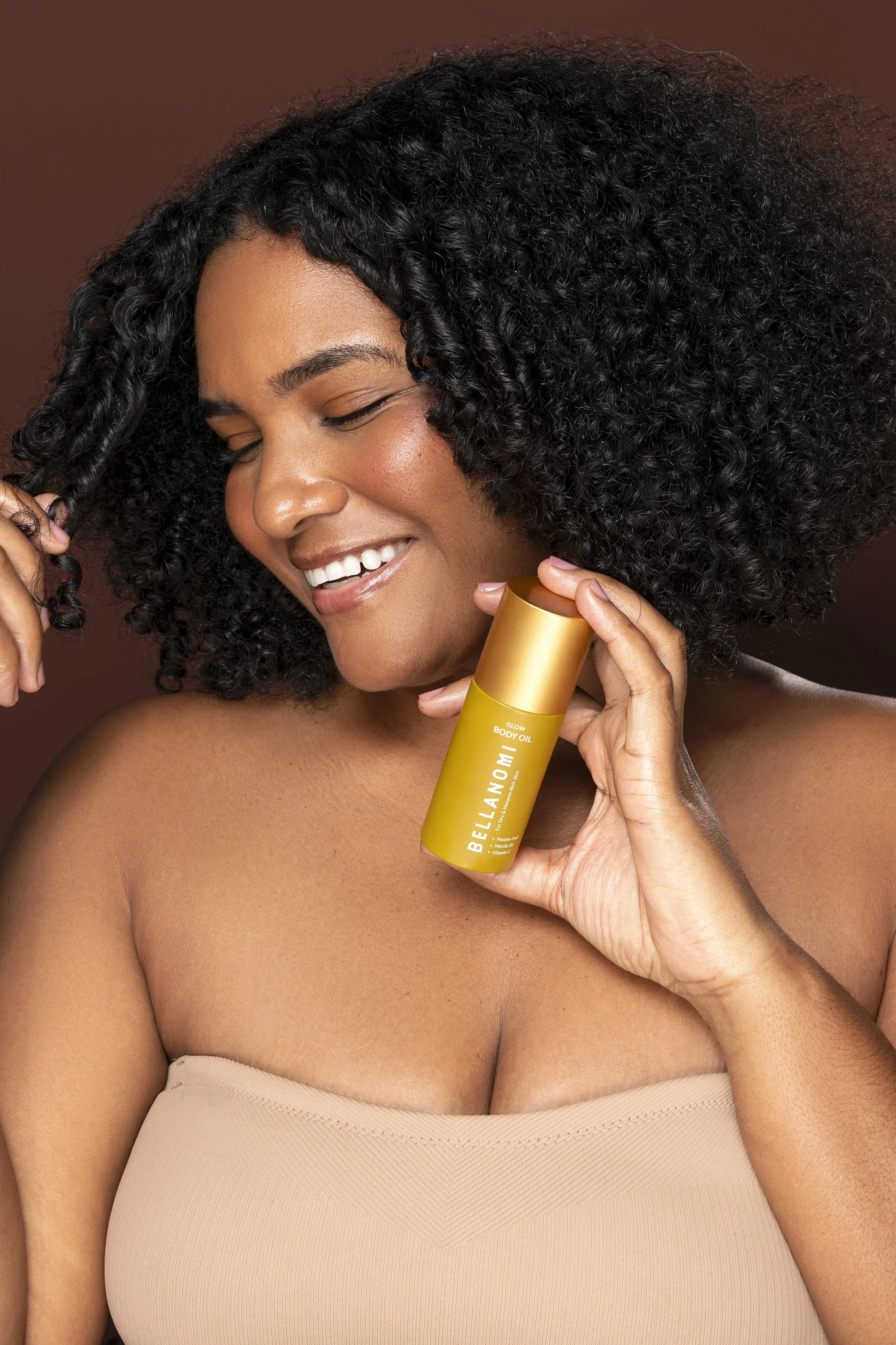  Luxury skincare branding photography for Bellanomi Skincare with model Tiana against a beige and brown backdrop photographed by Atlanta skincare photographer Caitlin Tabilog. 