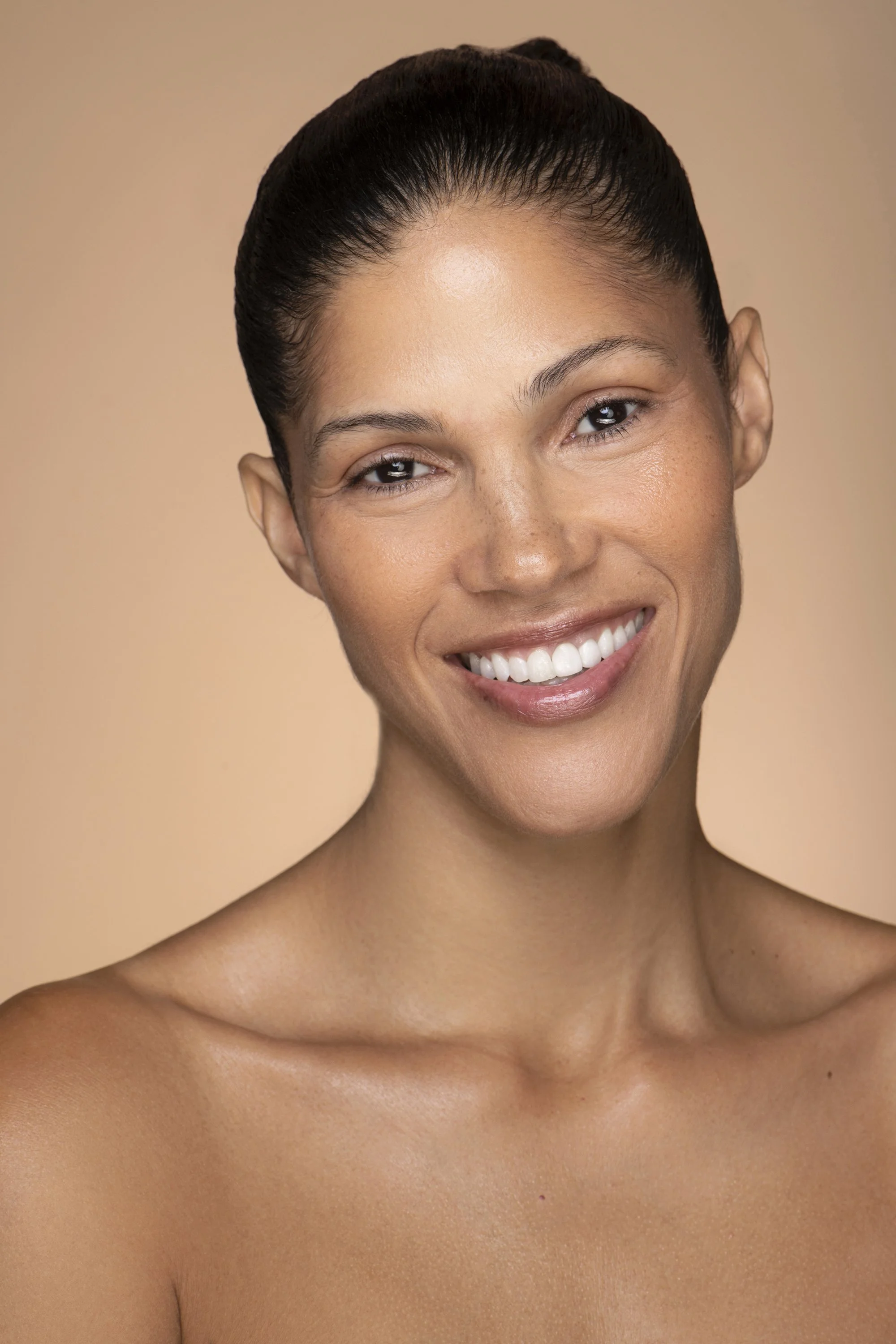  Atlanta beauty advertising photographer Caitlin Tabilog creates clean commercial skincare imagery for AYA Skin featuring a female Forward The Agency model photographed against a white seamless studio background at Arlos Studios. 