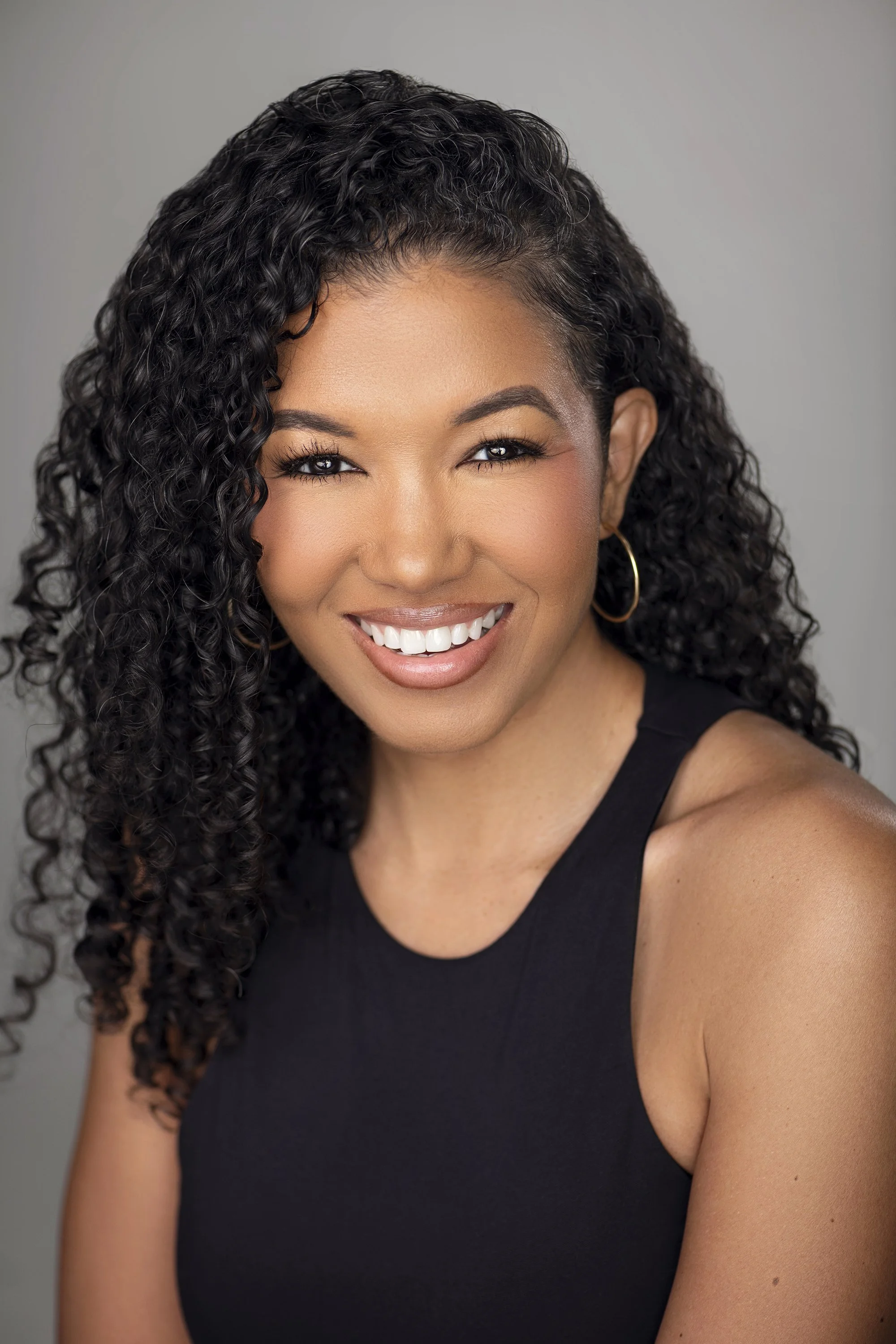 Atlanta commercial headshot photographer Caitlin Tabilog studio lifestyle portrait of Sada Jackson singer songwriter and model from Forward the Agency smiling against gray background professional lighting Atlanta Georgia beauty fashion editorial port